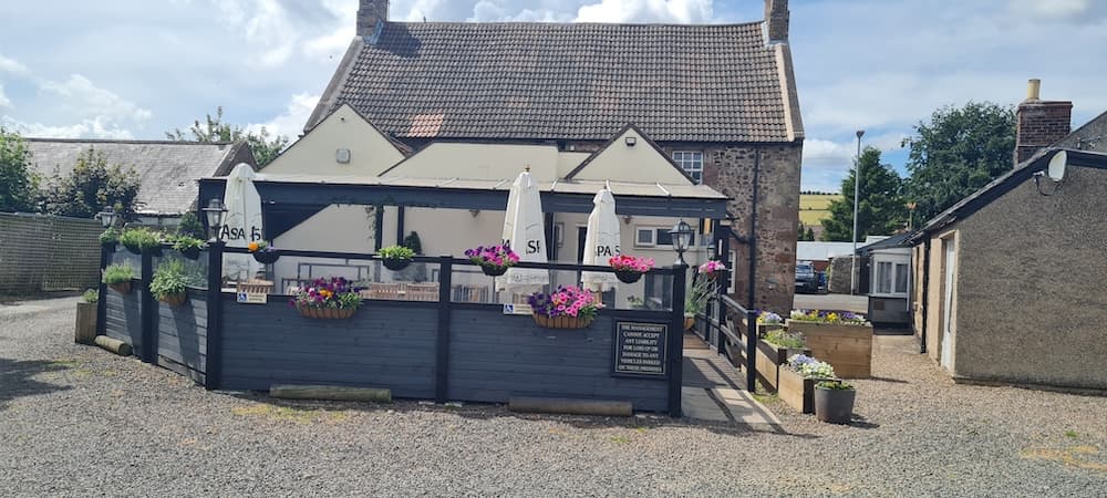 Front of the RedLion with Landlords Chris and Sophie